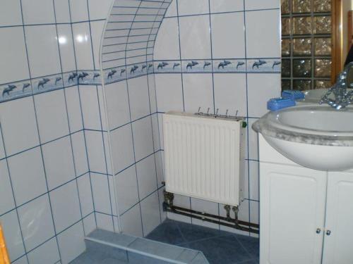 a bathroom with a sink and a toilet and a sink at Dóri Szálláshely in Sárospatak