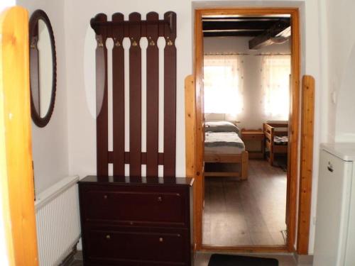 a room with a mirror and a dresser and a bedroom at Dóri Szálláshely in Sárospatak