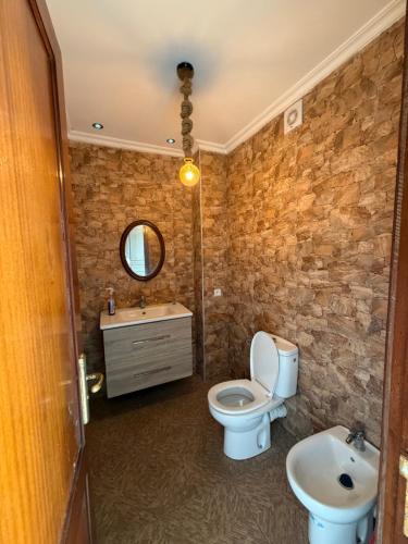 a bathroom with a toilet and a sink at Boustan homes in Cabo Negro
