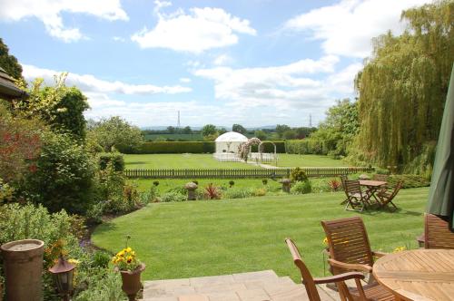 a garden with a gazebo and a lawn at Albright Hussey Manor in Shrewsbury