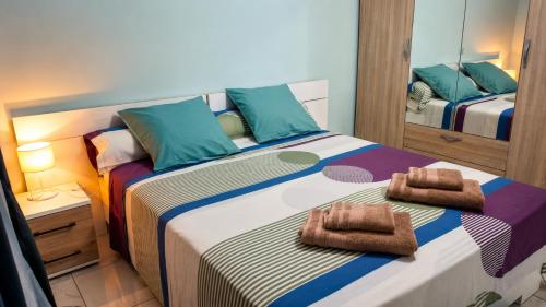 a bedroom with two beds with towels on them at Coeur A 2 in Macouria