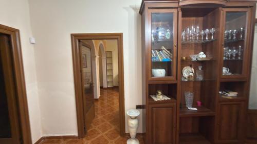 a room with a wooden cabinet and a hallway at Gioele apartament in Vlorë