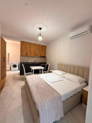 a bedroom with a bed and a table in it at Coastal Pine Appartment in Golem