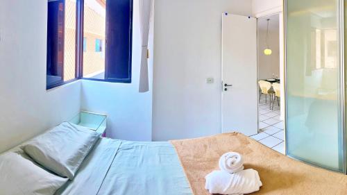 a room with a bed with a towel on it at Vacanze - Neo in Maceió