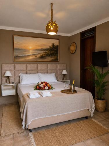 a bedroom with a large bed with flowers on it at Alisios Kite Lodge in Cumbuco