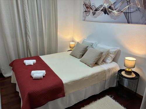 a bedroom with a bed with towels on it at Geninha Stay Aveiro in Aveiro