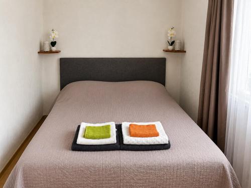 two pillows on a bed in a bedroom at Gunilak in Dombóvár