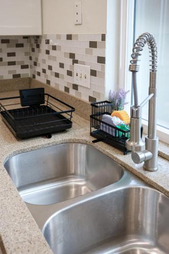 a stainless steel sink in a kitchen with a counter top at The Mira Mesa Gamezone in San Diego