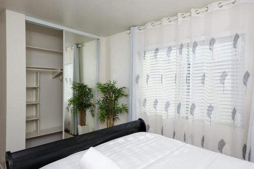 a bedroom with a bed and a window at The Mira Mesa Gamezone in San Diego