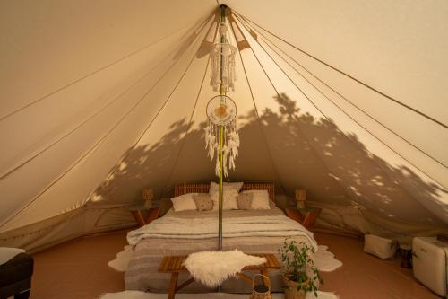 a tent with a bed in a room at Glamping Ty Západy in Stanový
