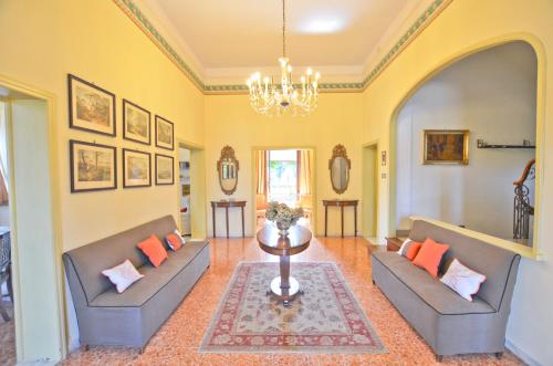 a living room with two couches and a table at Villa Bellavista - Tuscany panoramic view in Crespina