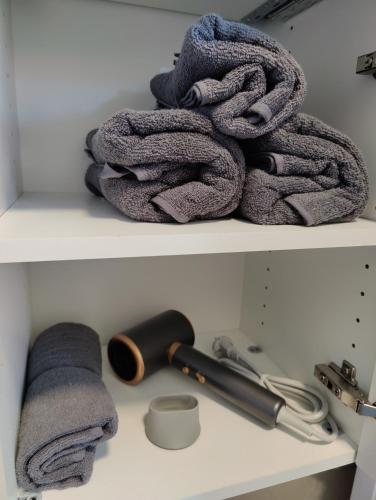 a pile of towels sitting on a shelf at Apartment Felicitas FEE in Tulln