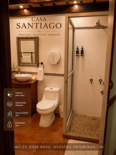 a bathroom with a white toilet and a shower at Casa Santiago Son 2 in Antigua Guatemala