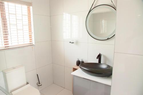 a white bathroom with a sink and a mirror at Ipanima palace in New Germany