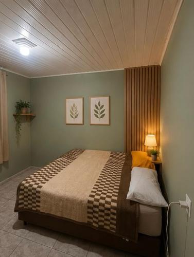 a bedroom with a large bed in a room at Destiny home in Curitiba