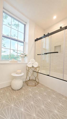 a bathroom with a shower and a table at Fox Point Landing Residences in Providence