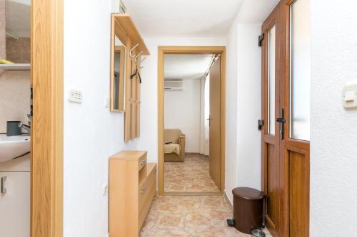 a hallway leading to a bathroom with a sink at Apartments with parking space Sutivan, Brac - 2846 in Sutivan