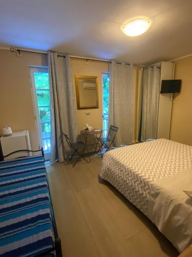 a bedroom with a bed and a table and a window at AFFITTACAMERE PIAZZA UNITA' in Monfalcone