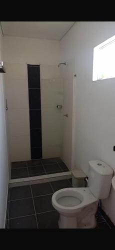 a bathroom with a white toilet and a shower at HOTEL ALMARr in Coveñas