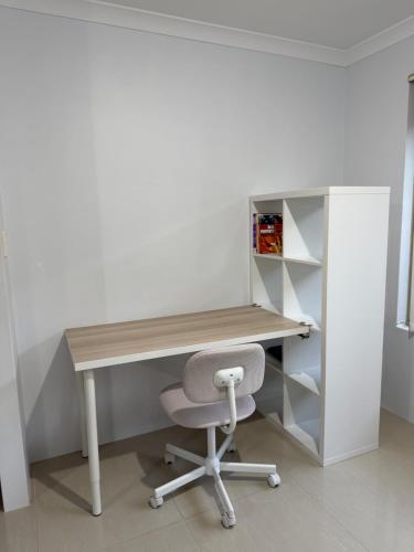 an office with a wooden desk and a chair at Sweet Single in Wellard