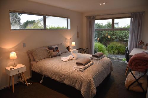 a woman laying on a bed in a bedroom at Rojan's Roost in Christchurch