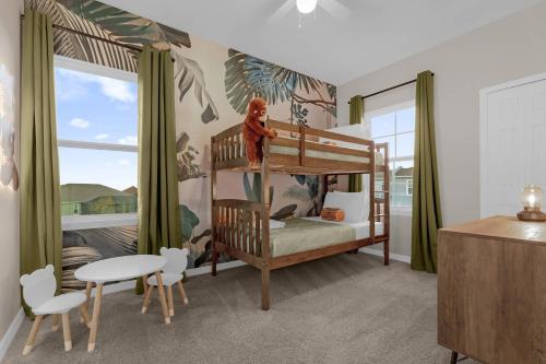 a childs bedroom with a bunk bed and a table at Brand New Themed Home With Lake View 11 in Davenport