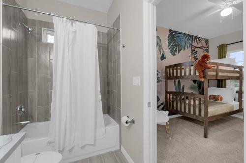 a bathroom with a shower and a baby crib at Brand New Themed Home With Lake View 11 in Davenport