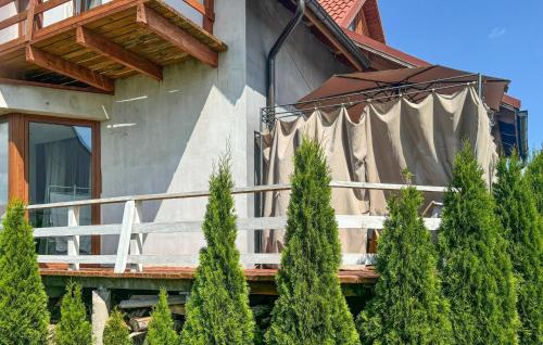 a house with a porch with trees in front of it at Gorgeous Home In Rybical With Wifi in Rybical