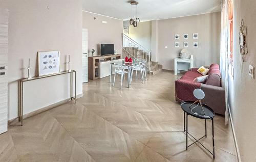 a living room with a couch and a table at Cozy Home In Capaccio in Foce del Sele
