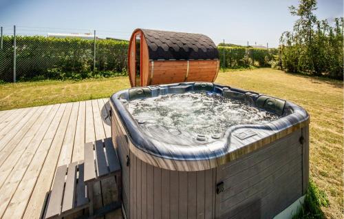 a hot tub on a wooden deck with a woodenigunigunigun at Gorgeous Home In Odder With Wifi in Odder