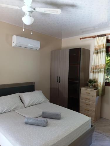 a bedroom with a bed with two pillows on it at Moorea Lodge Arii in Afareaitu