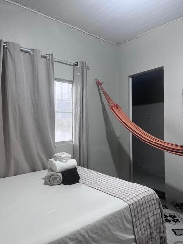 a bedroom with a bed with a hammock on it at Cantinho do Romeu in Soure