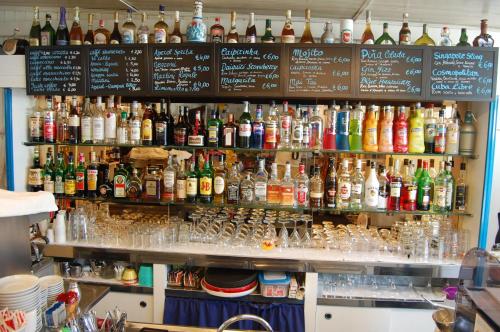 a bar with a lot of bottles of alcohol at Torre Turbolo Apartments in Massa Lubrense