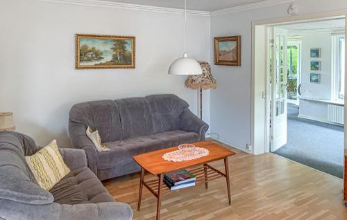a living room with a couch and a table at 2 Bedroom Pet Friendly Home In Ringkøbing in Ringkøbing