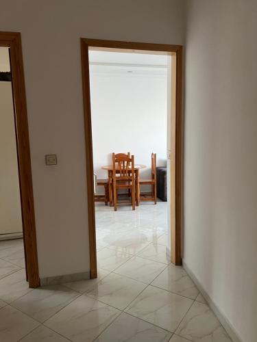 an open door to a dining room with a table at Mdiaq in M'diq