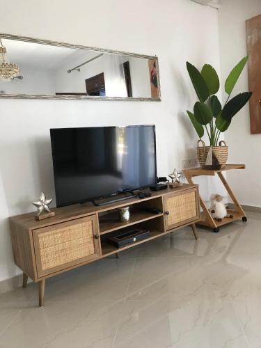 a television on a wooden entertainment center in a living room at Aeria Elegant Luxury Villa in Asprovalta