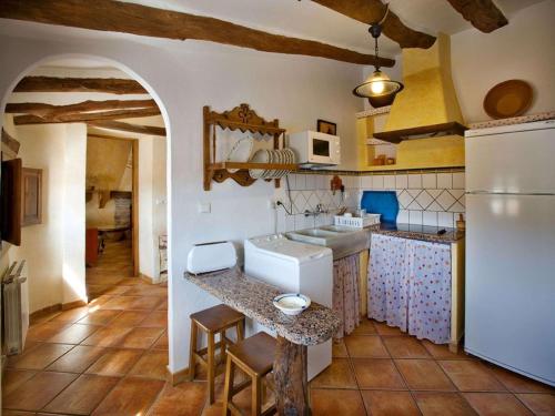 a kitchen with a sink and a refrigerator at 4-Guest Laroya Cottage with Pool in Laroya