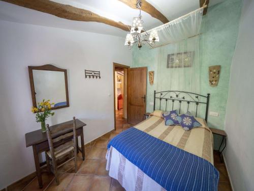 a bedroom with a bed and a mirror and a table at 4-Guest Laroya Cottage with Pool in Laroya
