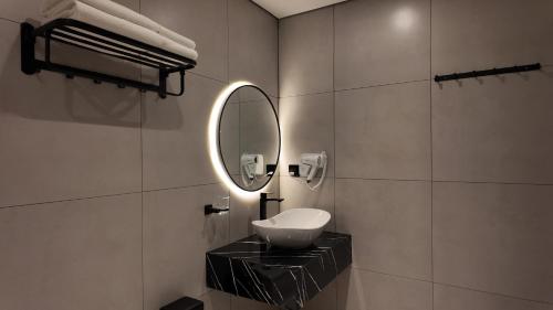 a bathroom with a sink and a mirror at LION 7 HOTEL in Can Tho