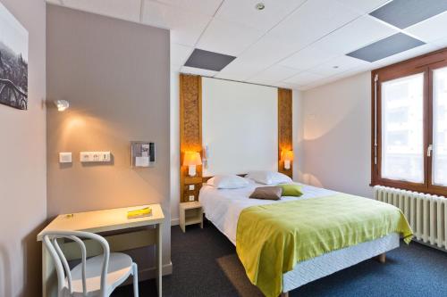 安錫的住宿－Logis - Hôtel Restaurant Bellevue Annecy，配有一张床、一张桌子和一张桌子的酒店客房