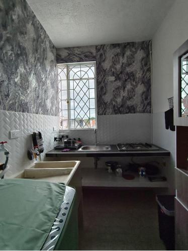 a kitchen with a sink and a window at Bahamas House in Ibagué