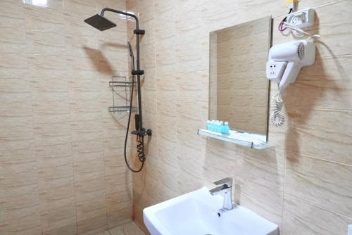 a bathroom with a shower and a sink and a mirror at Amor fati hotel Tashkent in Katartal