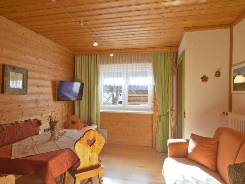 a living room with a couch and a table at Haus Hasslacher in Flattach