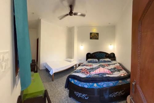 a bedroom with a bed and a table in it at The quiet corner homestay in Rudraprayāg