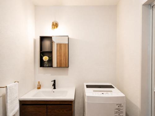 a bathroom with a sink and a washing machine at Knot in Shodoshima