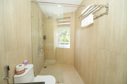 a bathroom with a white toilet and a shower at King Hotel in Quy Nhon
