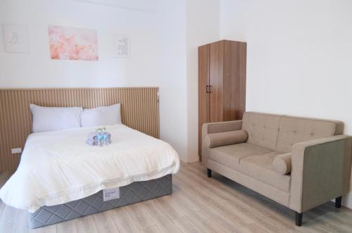 a bedroom with a bed and a chair at Airport Gem with Pool and Gym in Pusok
