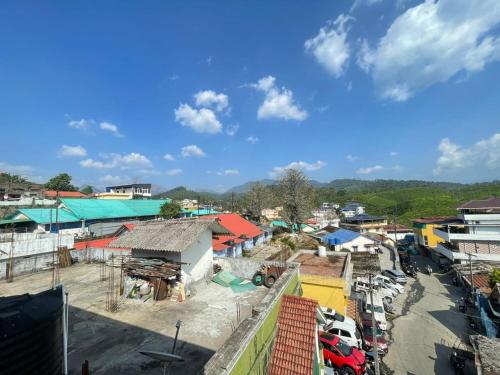 a small town with cars parked in a parking lot at Instahomestay in Vālpārai