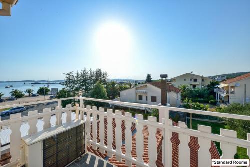 a white balcony with a view of the water at Hotel Joso in Sukošan