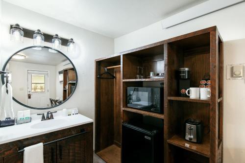 a bathroom with a sink and a mirror at Yellowstone Riverside Cottages in Gardiner